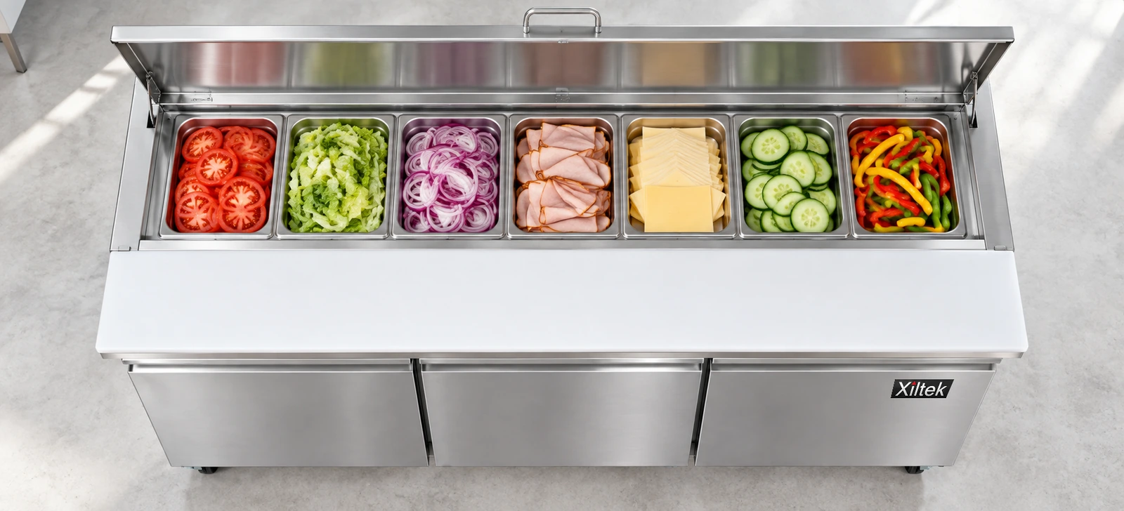 Top view of an open Xiltek sandwich prep table with ingredient pans